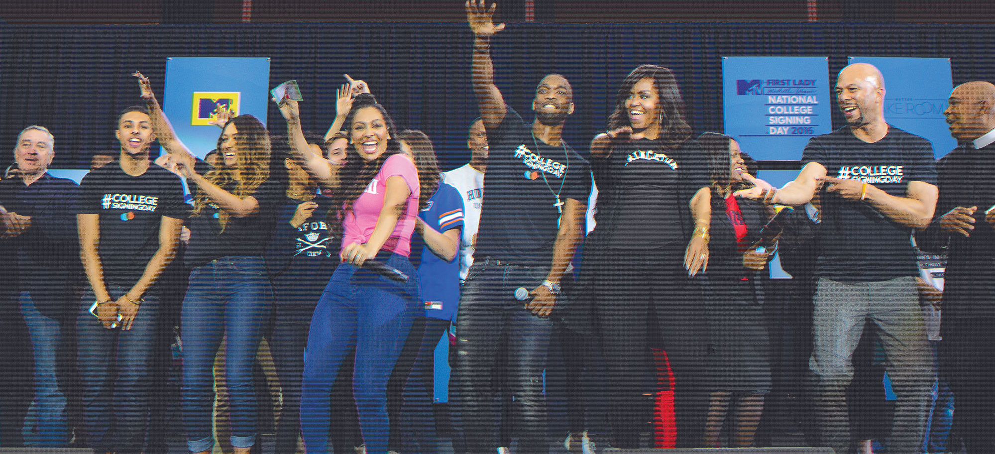 Michelle Obama and a group of students are on stage celebrating eduction.